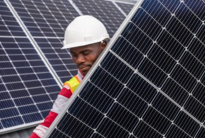Technician carefully connect and install solar panels on a residential rooftop. Houses in South Africa installing solar energy solutions